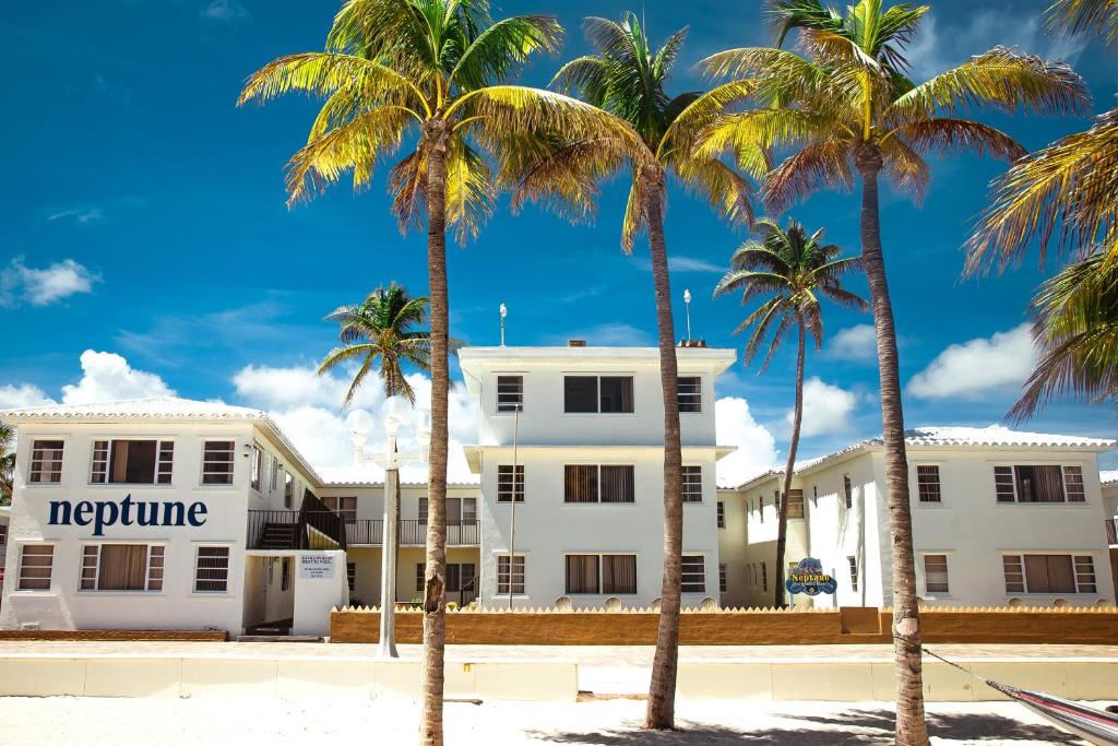 Neptune Hollywood Beach Hotel white exterior framed by palm trees in Hollywood Beach, Florida